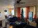 Living room with dark hardwood floors, and a Christmas tree at 2558 Robert Trent Jones Dr # 1427, Orlando, FL 32835