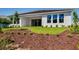 Well-manicured backyard featuring lush grass, landscaping, and a covered patio at 2987 Arranmore Dr, Ormond Beach, FL 32174