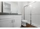 Modern bathroom features white cabinets, a shower, and a toilet on stylish wood-look flooring at 2987 Arranmore Dr, Ormond Beach, FL 32174