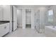 Stylish bathroom with double vanity, glass-enclosed shower, soaking tub, and open doorway to the closet at 2987 Arranmore Dr, Ormond Beach, FL 32174