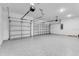 Spacious garage with epoxy flooring, overhead lighting, and ample room for parking and storage at 2987 Arranmore Dr, Ormond Beach, FL 32174