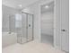 Bathroom showcasing a glass enclosed shower, soaking tub, and access to walk-in closet at 2995 Arranmore Dr, Ormond Beach, FL 32174