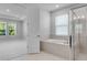 Bright bathroom featuring a soaking tub, glass shower and windows providing natural light at 2995 Arranmore Dr, Ormond Beach, FL 32174