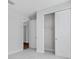 Bedroom featuring gray carpet, white walls, a sliding door closet and hardwood floor entryway at 2995 Arranmore Dr, Ormond Beach, FL 32174