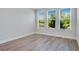 Bright bedroom featuring wood-look tile and multiple windows offering a pleasant view at 2995 Arranmore Dr, Ormond Beach, FL 32174