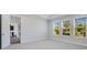 Comfortable bedroom with soft carpeting, recessed lighting, and large windows overlooking a lush landscape at 2995 Arranmore Dr, Ormond Beach, FL 32174