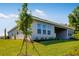 Well-maintained home with a lush lawn, garden, and a partially covered patio at 2995 Arranmore Dr, Ormond Beach, FL 32174