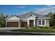 Two-story home with brown double garage doors and gray siding at 2995 Arranmore Dr, Ormond Beach, FL 32174