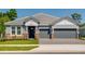 Beautiful single-story home with a two-car garage and stone accents on the facade at 2995 Arranmore Dr, Ormond Beach, FL 32174