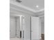 A hallway with multiple doors and a decorative ceiling at 2995 Arranmore Dr, Ormond Beach, FL 32174