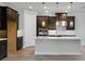 Modern kitchen with white countertops, dark wood cabinetry, and stainless steel appliances at 2995 Arranmore Dr, Ormond Beach, FL 32174