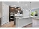Modern kitchen features a large island, stainless steel appliances, and pendant lighting at 2995 Arranmore Dr, Ormond Beach, FL 32174