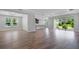 Open concept living area with wood-look tile flooring, lots of natural light, and an open kitchen at 2995 Arranmore Dr, Ormond Beach, FL 32174