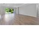 Spacious living room with wood-look tile flooring and sliding glass doors to the backyard at 2995 Arranmore Dr, Ormond Beach, FL 32174
