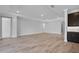 Spacious living room featuring wood-look tile flooring, recessed lighting, and crown molding at 2995 Arranmore Dr, Ormond Beach, FL 32174