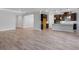 Open-concept living room showcases wood-look tile, modern lighting, and a seamless transition to the kitchen at 2995 Arranmore Dr, Ormond Beach, FL 32174