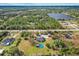 Aerial view of home, pool, and surrounding land near a lake at 3401 Abalone Blvd, Orlando, FL 32833