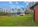 Backyard with a pool and a wooded area in the background at 3401 Abalone Blvd, Orlando, FL 32833