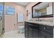Bathroom boasts granite countertop, dark vanity, and tiled floor at 3401 Abalone Blvd, Orlando, FL 32833