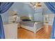 Spacious primary bedroom featuring a vaulted ceiling, wood floors, and ensuite bathroom at 3401 Abalone Blvd, Orlando, FL 32833