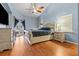 Main bedroom with light wood floors, a large bed, and plenty of natural light at 3401 Abalone Blvd, Orlando, FL 32833