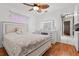 Bright bedroom featuring a large vanity, ceiling fan, and wood floors at 3401 Abalone Blvd, Orlando, FL 32833