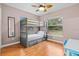 Bedroom with bunk beds, wood floors, and large window at 3401 Abalone Blvd, Orlando, FL 32833