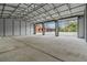 Spacious garage with high ceilings, concrete floors and multiple garage doors for easy access at 3401 Abalone Blvd, Orlando, FL 32833