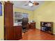 Bright home office features built-in shelving and hardwood floors at 3401 Abalone Blvd, Orlando, FL 32833