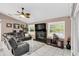 Inviting living room with a cozy fireplace, comfortable leather seating, and ample natural light at 3401 Abalone Blvd, Orlando, FL 32833