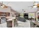 Open concept living room with bar seating, large screen TV and views to kitchen and backyard at 3401 Abalone Blvd, Orlando, FL 32833