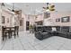 Open living area with a large leather sectional, adjacent to kitchen and dining areas at 3401 Abalone Blvd, Orlando, FL 32833