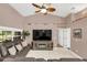 Comfortable living room with tile floors, a large flat-screen TV, and a view of the backyard at 3401 Abalone Blvd, Orlando, FL 32833