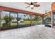 Screened patio with tile floors and a view of the backyard and wooded area at 3401 Abalone Blvd, Orlando, FL 32833