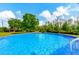 Inviting above ground pool with a wooden deck and surrounding trees at 3401 Abalone Blvd, Orlando, FL 32833