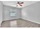 Bright bedroom with wood-look floors and ceiling fan at 4340 Sandhurst Dr, Orlando, FL 32817