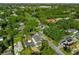 This aerial showcases a home in a lush neighborhood near a golf course and pond, offering beauty and recreational options at 500 W Hazel St, Orlando, FL 32804