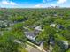 An aerial view of a charming home surrounded by lush greenery, with the city skyline visible in the distance at 500 W Hazel St, Orlando, FL 32804
