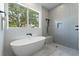 This spacious bathroom offers a soaking tub, a walk-in shower, and a view of the landscape at 500 W Hazel St, Orlando, FL 32804