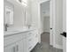 Bright bathroom features a double vanity with white cabinets, modern fixtures, and access to the bedroom at 500 W Hazel St, Orlando, FL 32804