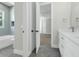 Bathroom with grey floors, white vanity, and a view into the bedroom at 500 W Hazel St, Orlando, FL 32804
