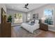 Bedroom featuring a large window, wood floors, ceiling fan, and stylish decor at 500 W Hazel St, Orlando, FL 32804
