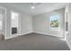 Bedroom with neutral walls and carpet, plus a bright window and bathroom access at 500 W Hazel St, Orlando, FL 32804