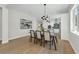 Bright dining room showcasing modern light fixture, hardwood floors, and an adjacent kitchen at 500 W Hazel St, Orlando, FL 32804