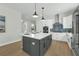 Stylish kitchen island featuring quartz countertops, modern appliances, and gray cabinetry at 500 W Hazel St, Orlando, FL 32804