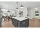 Gray kitchen island with white counter tops connecting to dining and living room at 500 W Hazel St, Orlando, FL 32804