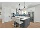 Modern kitchen featuring white cabinets, a gray island with seating, and stainless steel appliances at 500 W Hazel St, Orlando, FL 32804