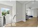 Bright second-story landing with wood floors and views of the living area and the landscaped yard at 500 W Hazel St, Orlando, FL 32804
