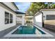 Backyard pool area with blue tiles, grey brick, and a white fence at 500 W Hazel St, Orlando, FL 32804