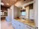 Bathroom with granite vanity, large mirror, and brick-like tile at 5001 Latrobe Dr, Windermere, FL 34786